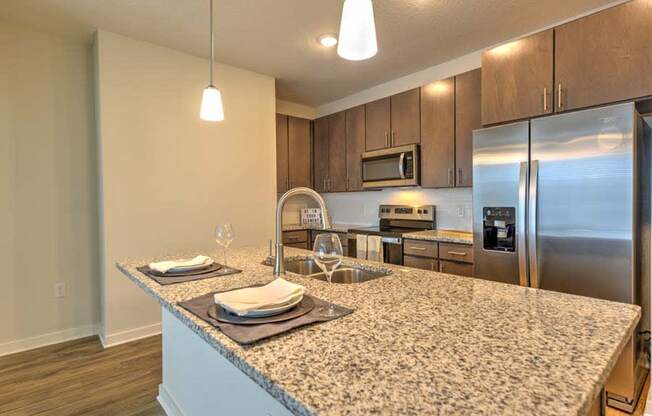 a kitchen with a large counter top next to a refrigerator  at Fusion, Jacksonville, Florida