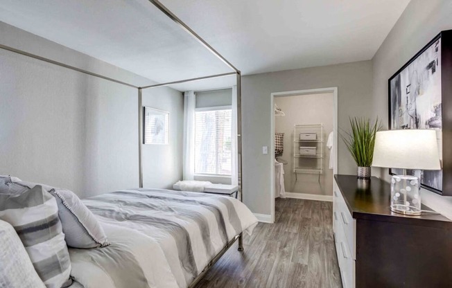 a bedroom with a large bed and a mirror