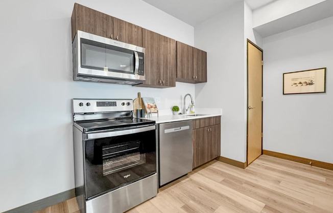 a kitchen with stainless steel appliances and a microwave