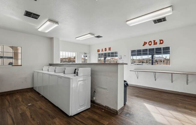 A laundromat with a washer and dryer in it.