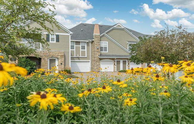 a close up of a flower garden in front of a building