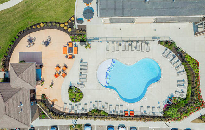 an aerial view of a swimming pool in a parking lot