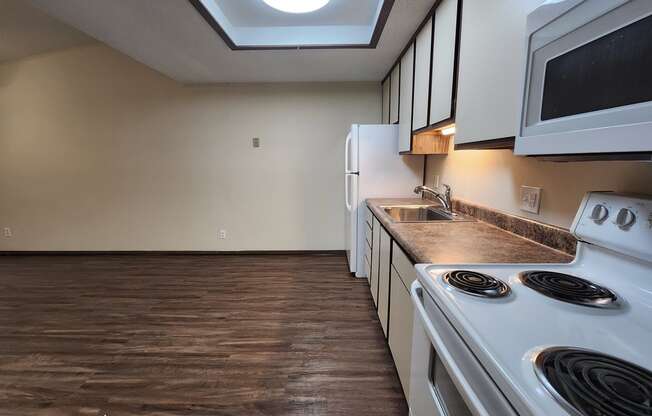 a kitchen with white appliances and a white stove top oven