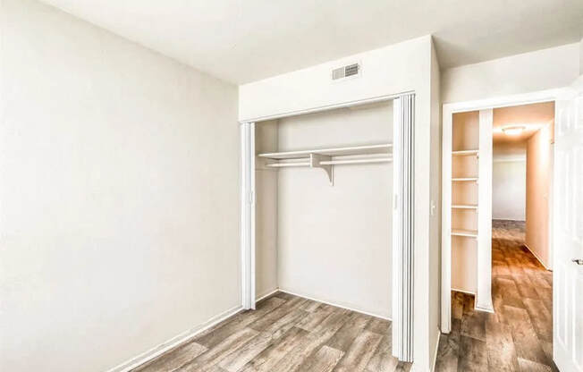 an empty bedroom with a closet and a mirrored closet door at Gates of West Bay, Norfolk, VA