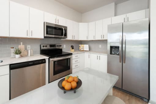 a kitchen with stainless steel appliances and white cabinets at The Waterford At Rocketts Landing Apartments, PRG Real Estate, Richmond, Virginia