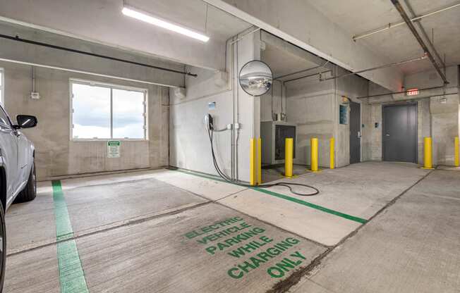a clean garage with a car and a hose on the floor