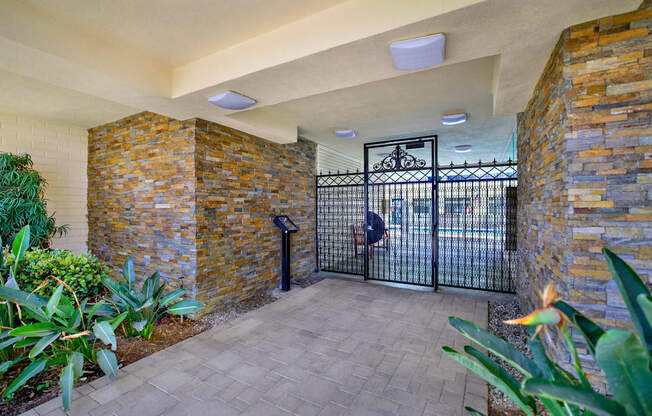 the entrance to a building with a gate at Olive Tree Apartments, California