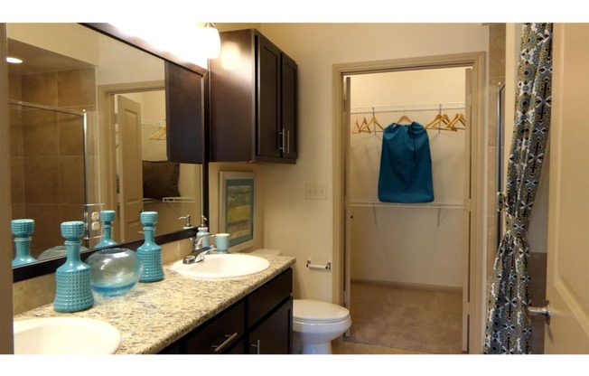 a bathroom with a toilet sink and shower