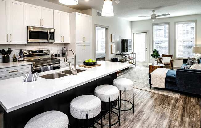 Studio, one, and two-bedroom apartment homes with stainless steel appliances, quarts countertops, designer cabinetry, large kitchens, luxury vinyl plank flooring, high vaulted ceilings, high-end lighting, in-unit washer and dryer, and energy efficient windows at Fireside at Waukee in Waukee, IA