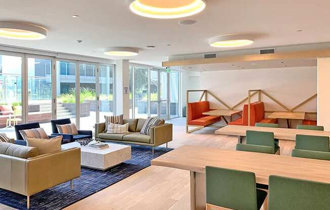 A modern living room with a sofa set, a coffee table, and a dining table.