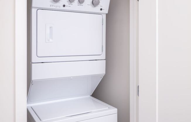 a white washer and dryer in a closet at Maven on Broadway, Minnesota