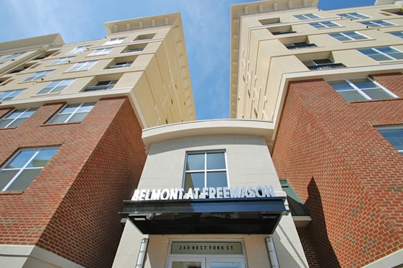 Belmont at Freemason leasing office entrance with community sign over doors