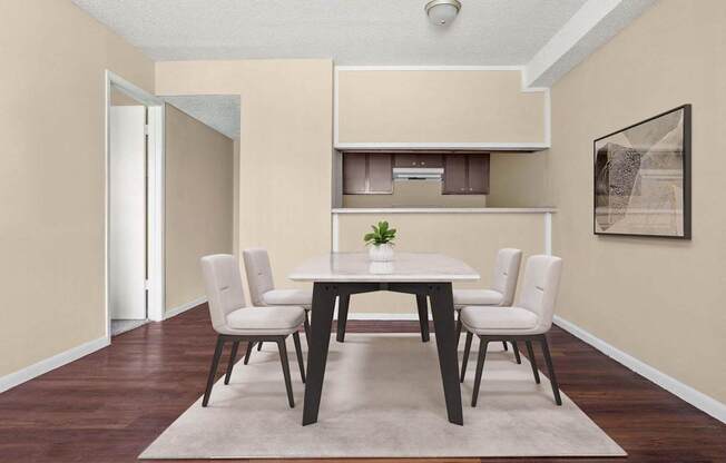 A dining room with a table and chairs.