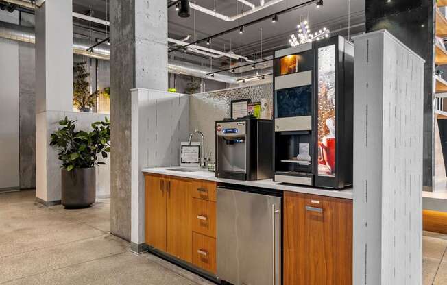 A modern kitchen with wooden cabinets and a stainless steel refrigerator.