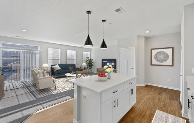 an open kitchen and living room with white cabinets and a white island