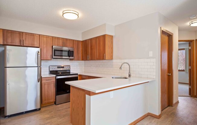 a kitchen with a white counter top and a refrigerator