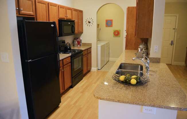 apartment kitchen with washer and dryers