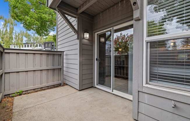 a patio with a sliding glass door and a deck