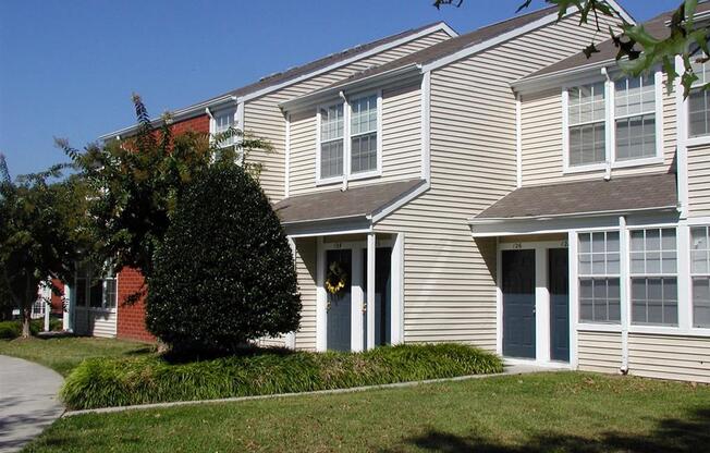 a large house with a sidewalk in front of it