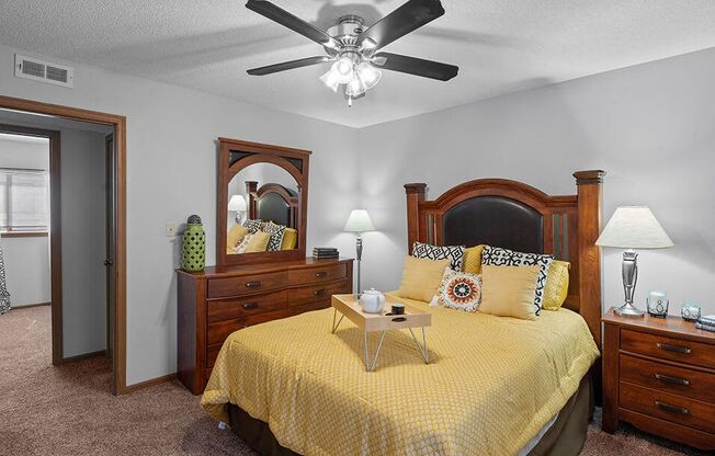 a bedroom with a bed and a ceiling fan