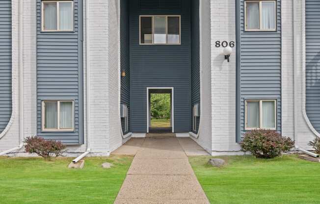 the front of a building with a walkway and a door