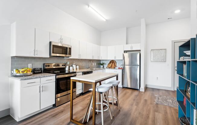 a kitchen with white cabinetry and stainless steel appliances