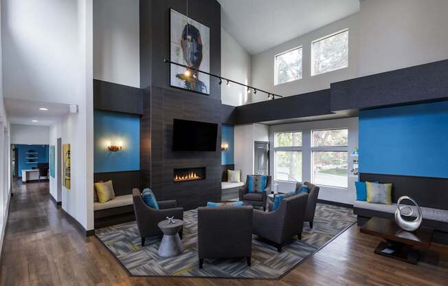 A modern living room with a fireplace and a painting on the wall.
