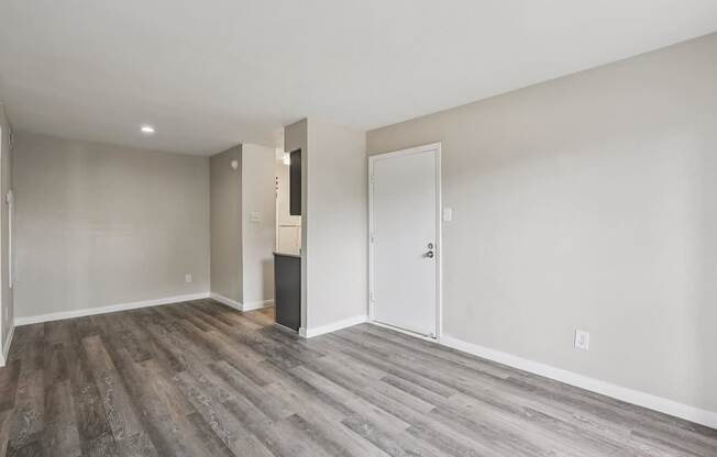 A room with a white door and a white wall.