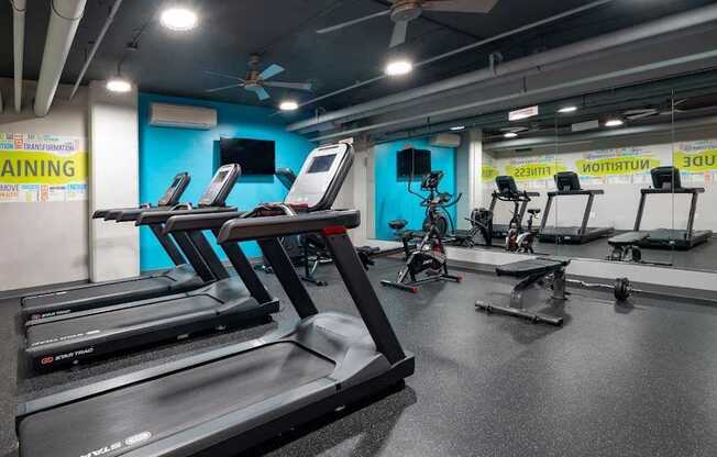 A gym with treadmills and exercise bikes.