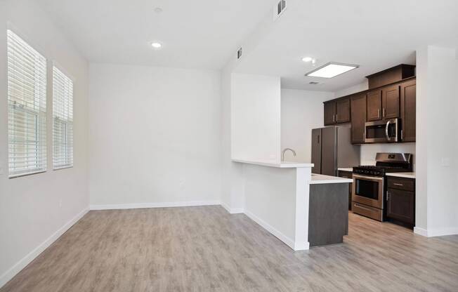a kitchen and living room in a 555 waverly unit at Rancho Belago, Moreno Valley
