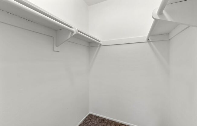 a small room with white walls and white shelves