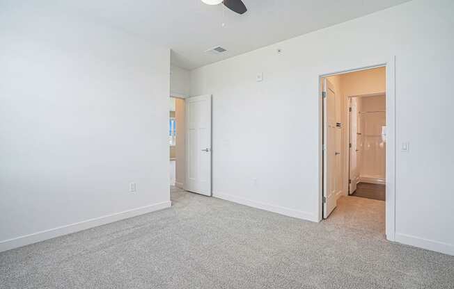 a bedroom with white walls and carpet at Meadowbrooke Apartment Homes, Grand Rapids