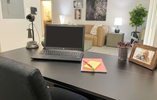 a laptop computer sitting on a desk in a living room