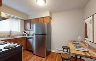 a kitchen with stainless steel appliances and a wooden table