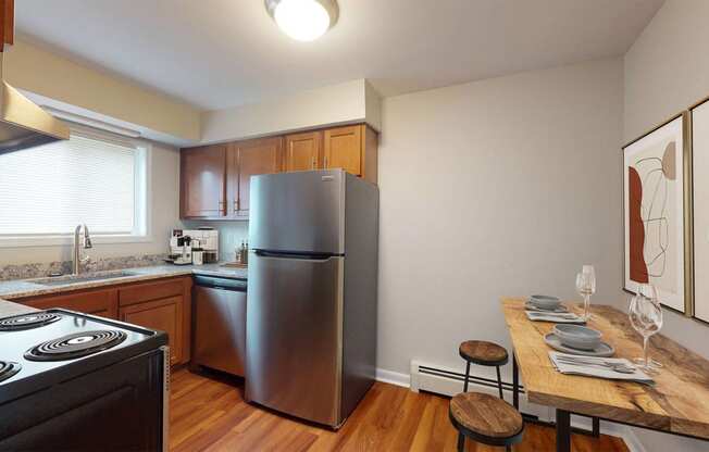 a kitchen with stainless steel appliances and a wooden table
