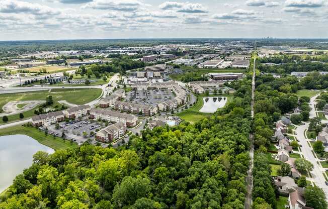 an aerial view of a city with houses and trees