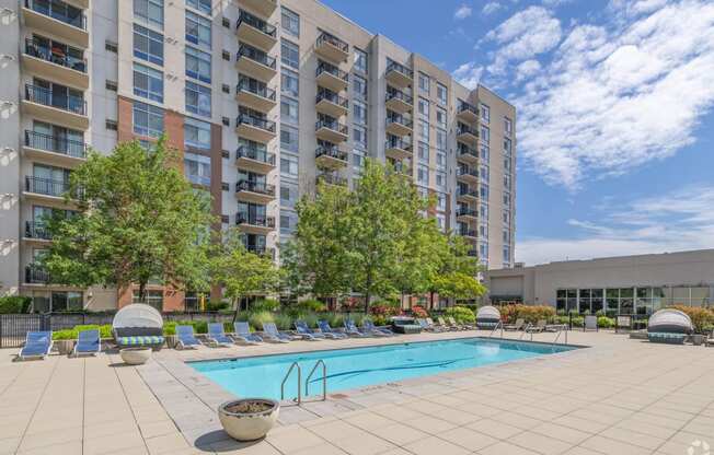 a swimming pool in front of an apartment building