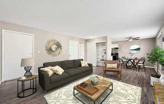 A living room with a grey couch, a coffee table, and a dining table with chairs.