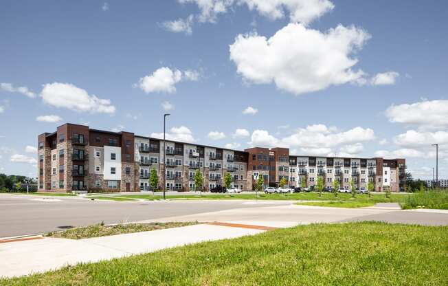 a large apartment building on the side of a road