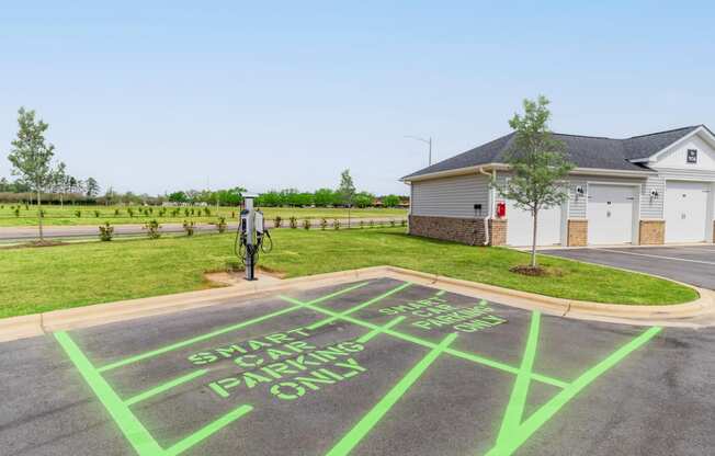 a parking lot with a message painted on it in front of a house