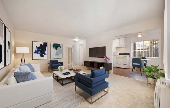 A living room with a white couch, a blue chair, and a television.