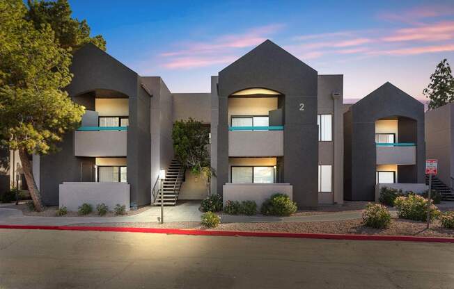 A modern building with a flat roof and a staircase leading to the entrance.