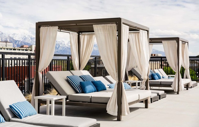 a rendering of the rooftop of a hotel with lounge chairs and umbrellas