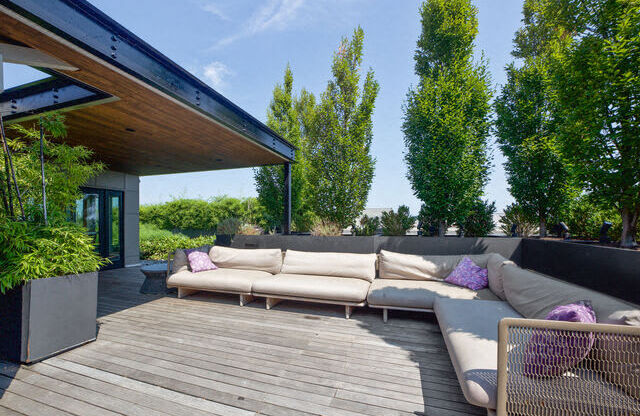 a patio with couches on a wooden deck