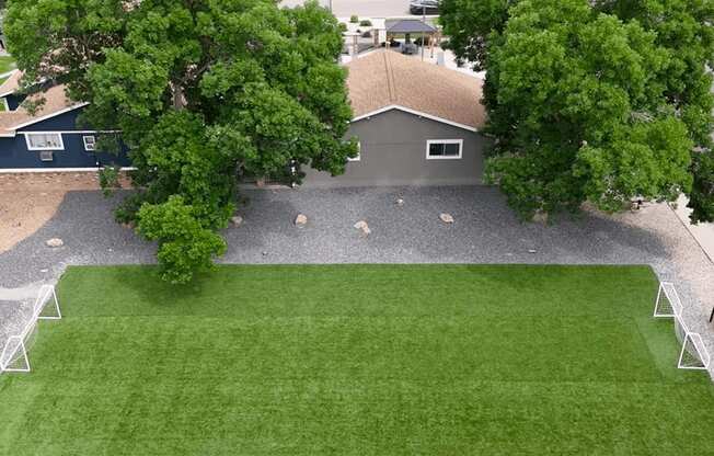 A house with a grey roof and a green lawn.