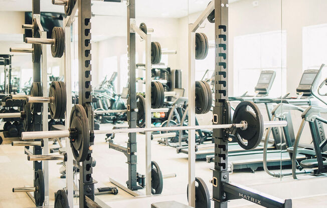 a gym with weights and cardio equipment in it