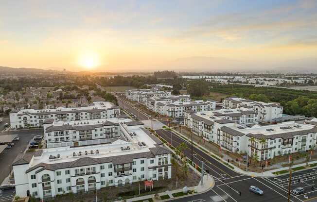 an aerial view of an urban city at sunset