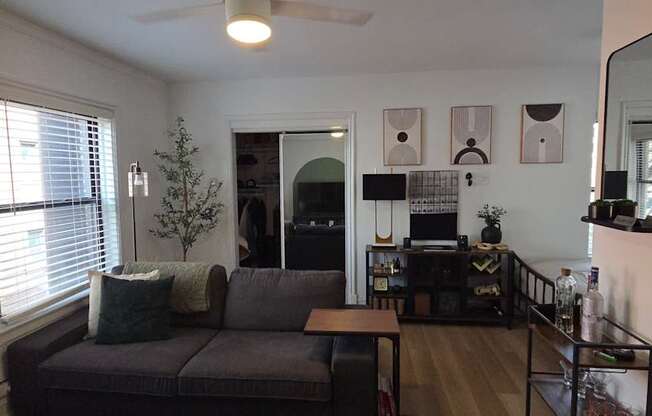 A living room with a grey couch and a coffee table.