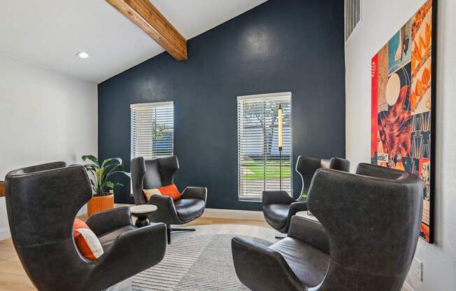 A room with black walls and a large painting on the wall.