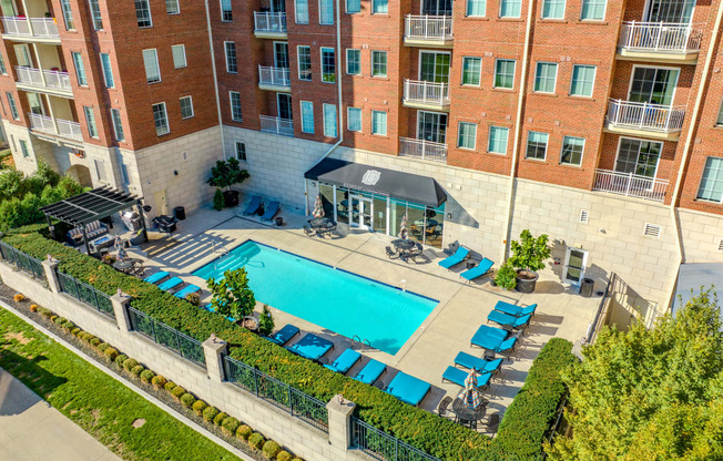 an aerial view of an apartment building with a swimming pool